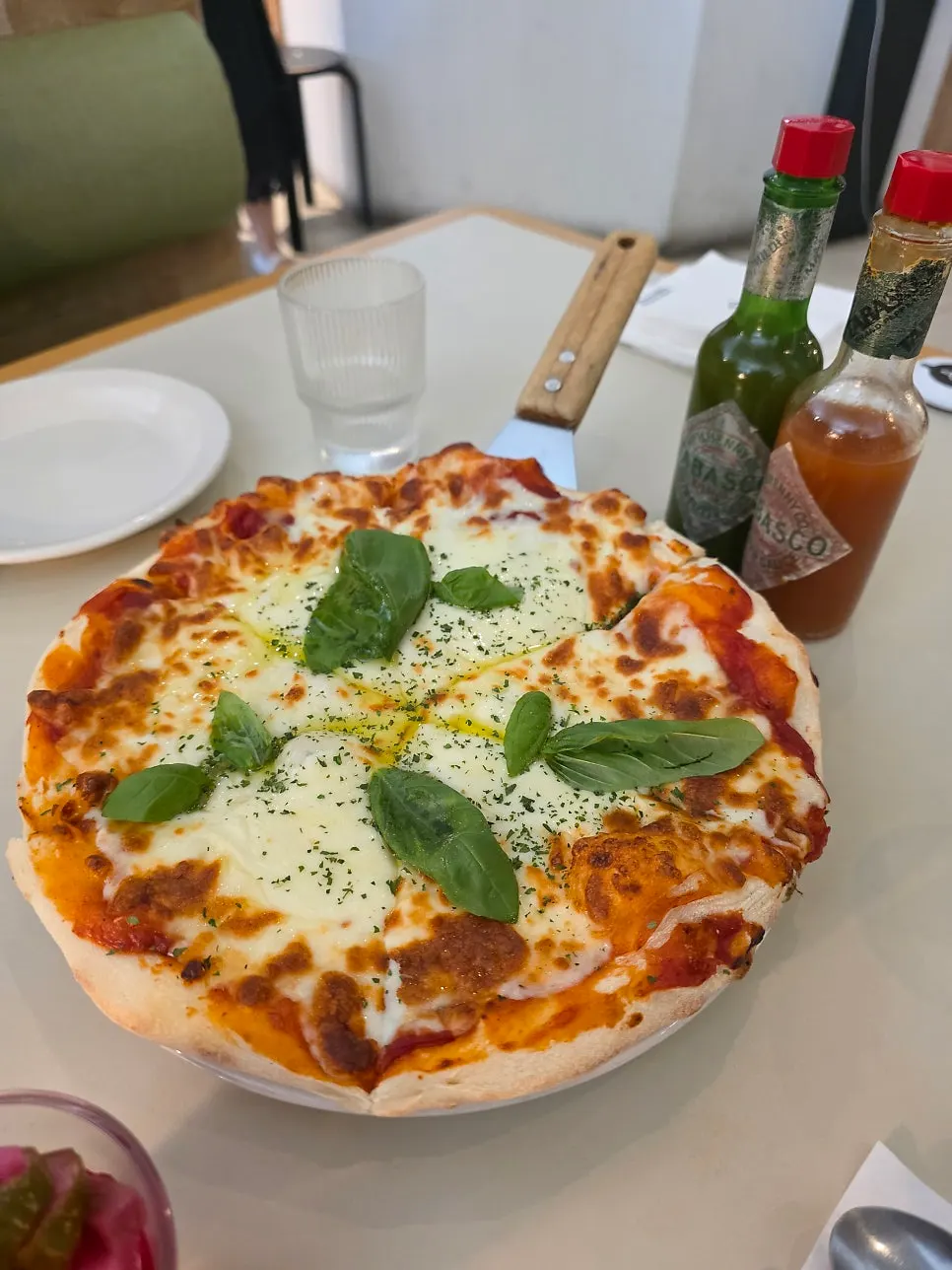 Margherita pizza served with oil drizzled on top