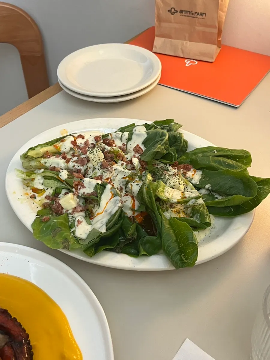 Grilled romaine salad topped with bacon chips