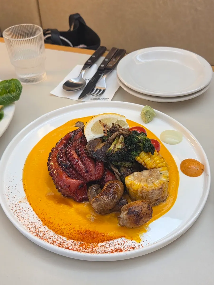 A piece of rock octopus leg dipped in sauce