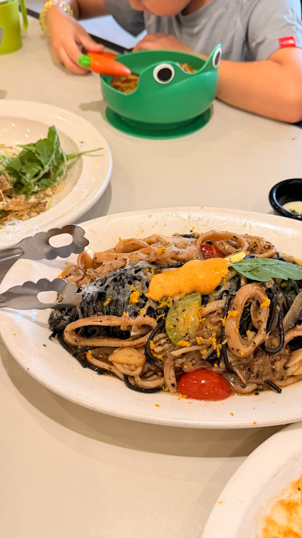 Kids' pasta served out into a frog-shaped bowl