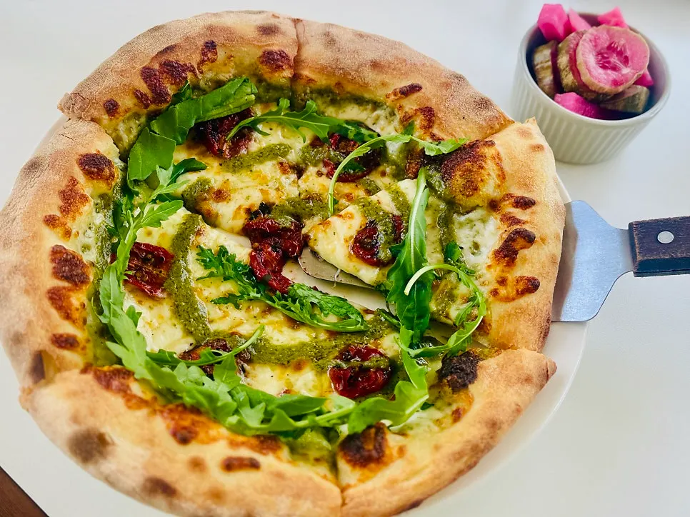 Thin-crust arugula prosciutto pizza