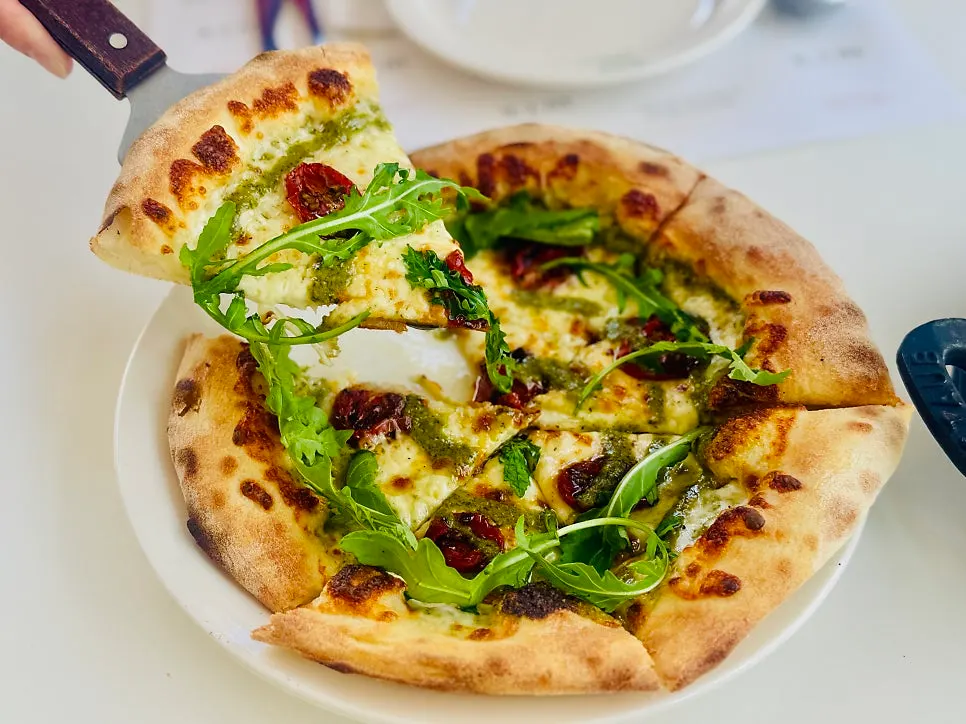 Prosciutto pizza with side dishes