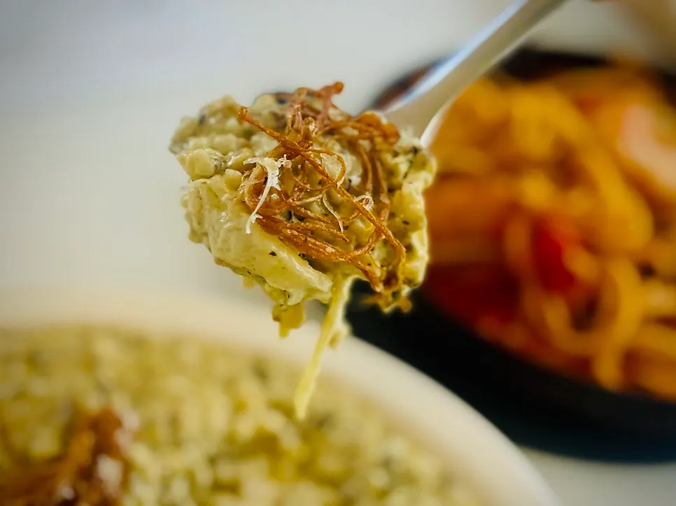 Risotto topped with fried enoki mushrooms