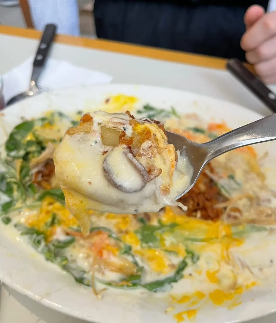 A plate of cream cheese gnocchi loaded with sauce