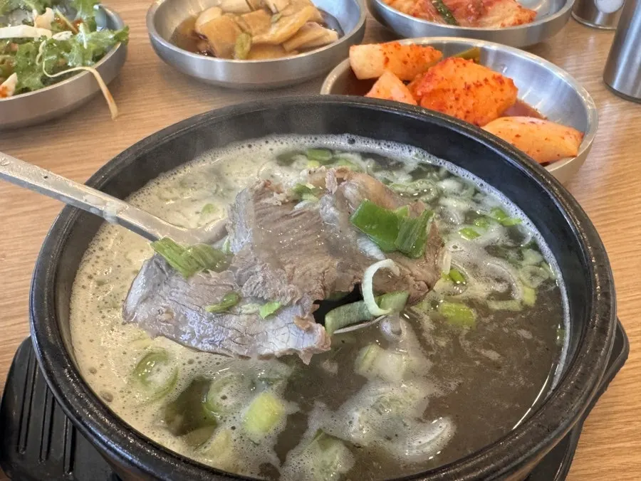 Close-up of a spoonful of gomtang broth