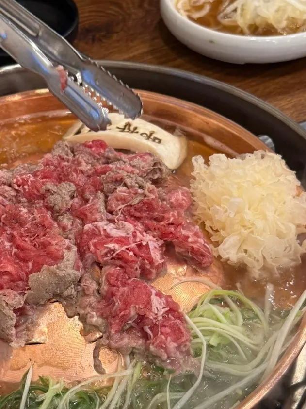 Thin bulgogi slices cooking in steam