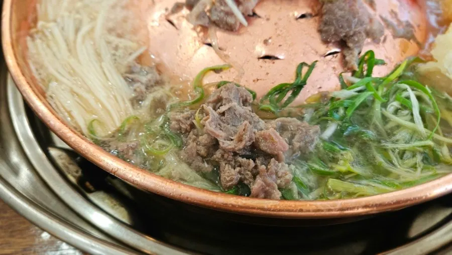 Plate of broth and vegetables together
