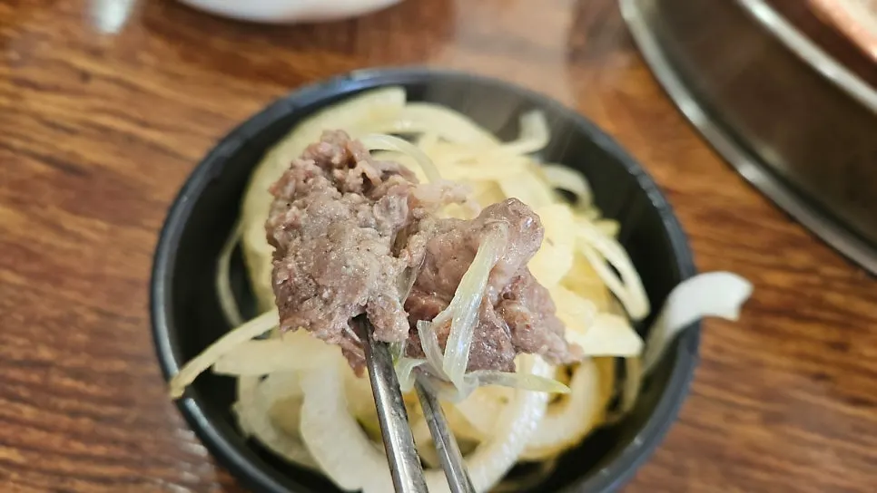A bowl of rice mixed with bulgogi broth