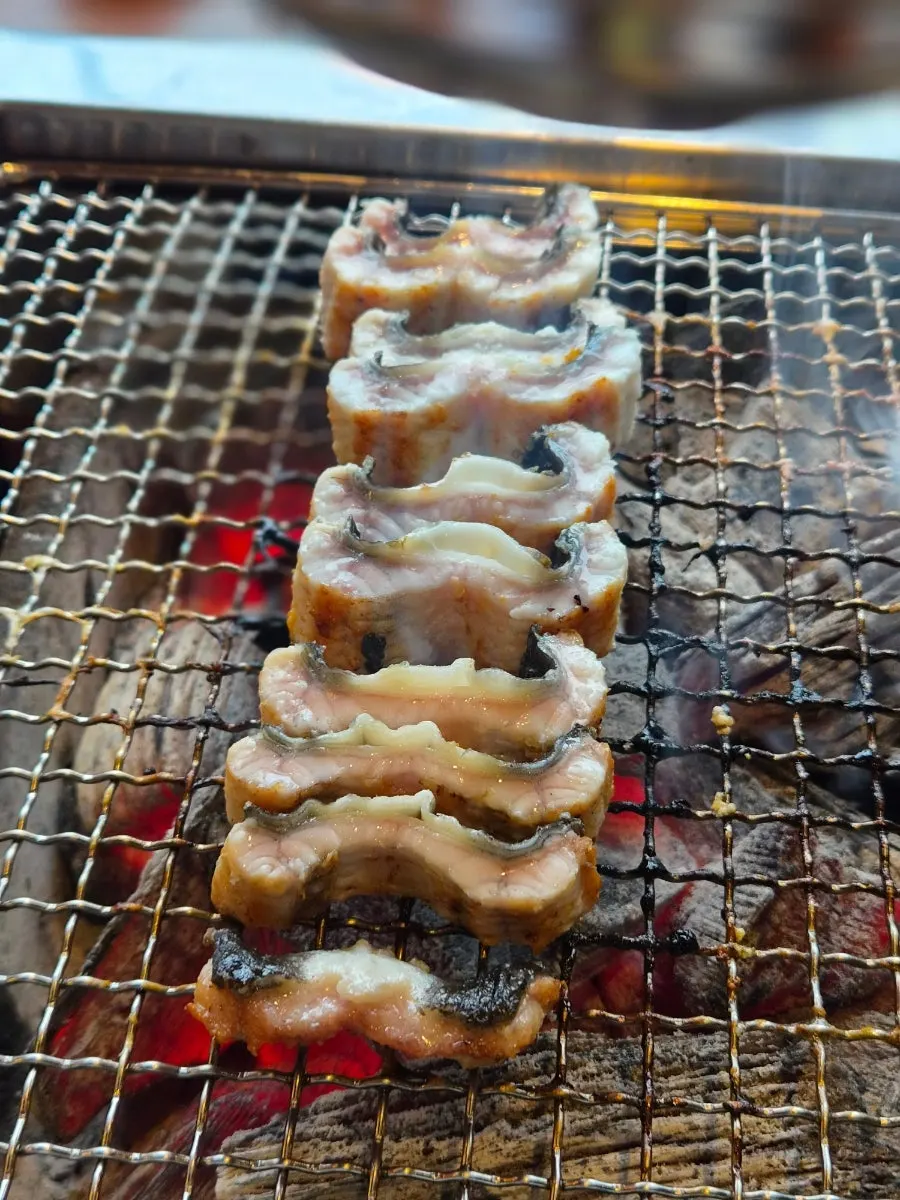 Grilled eel cut into even pieces and stood upright