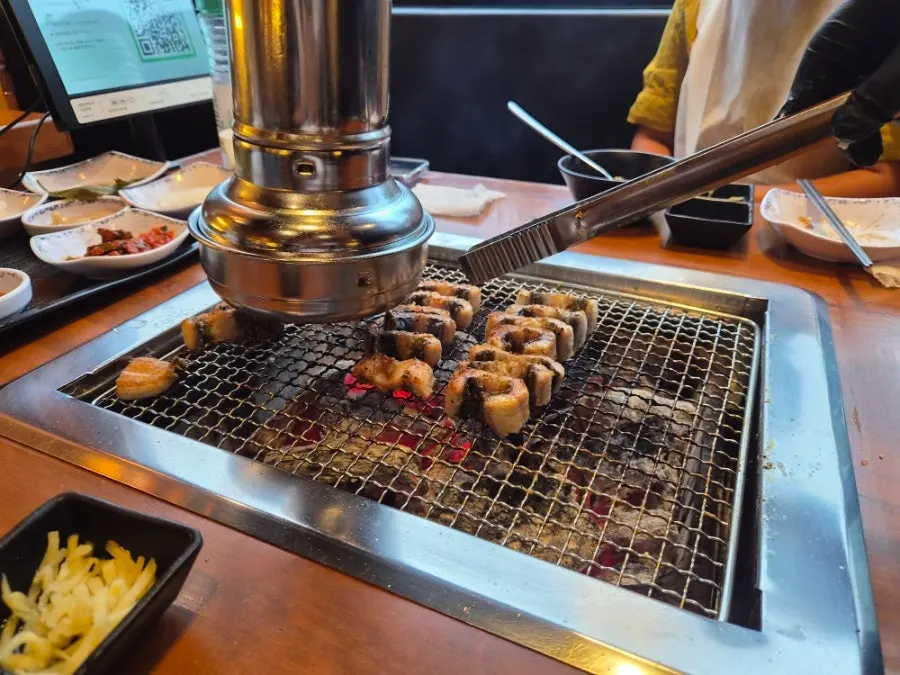 A second eel added to the grill plate