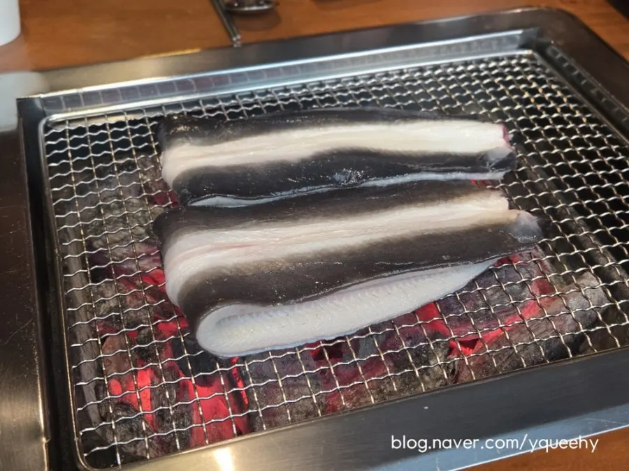 Large eel as staff begin grilling it