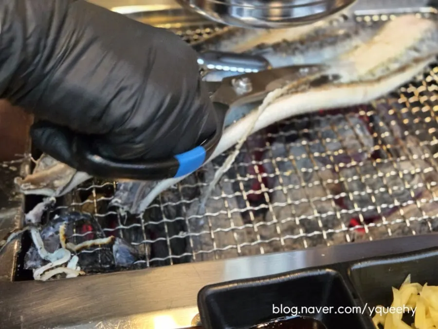 Staff trimming and grilling eel
