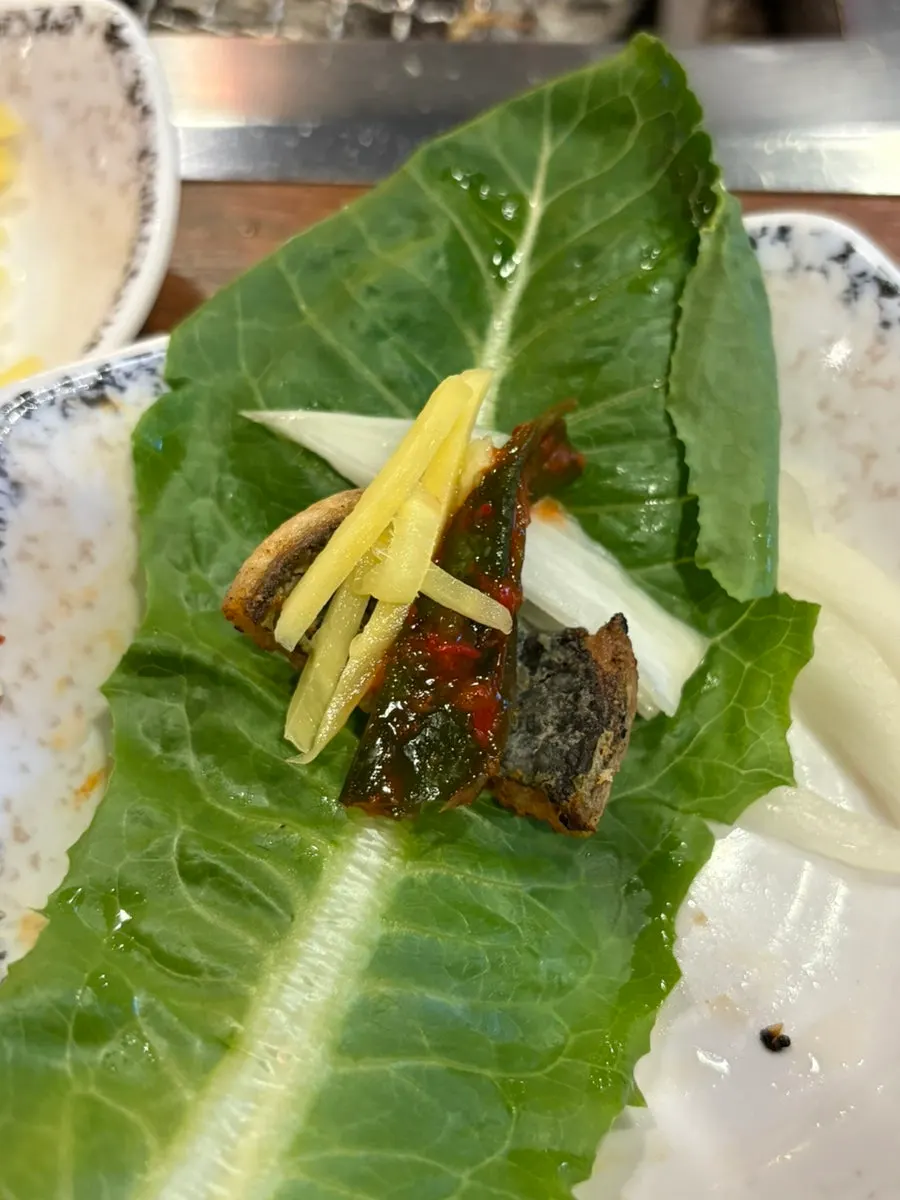 Staff grilling eel through the final pieces