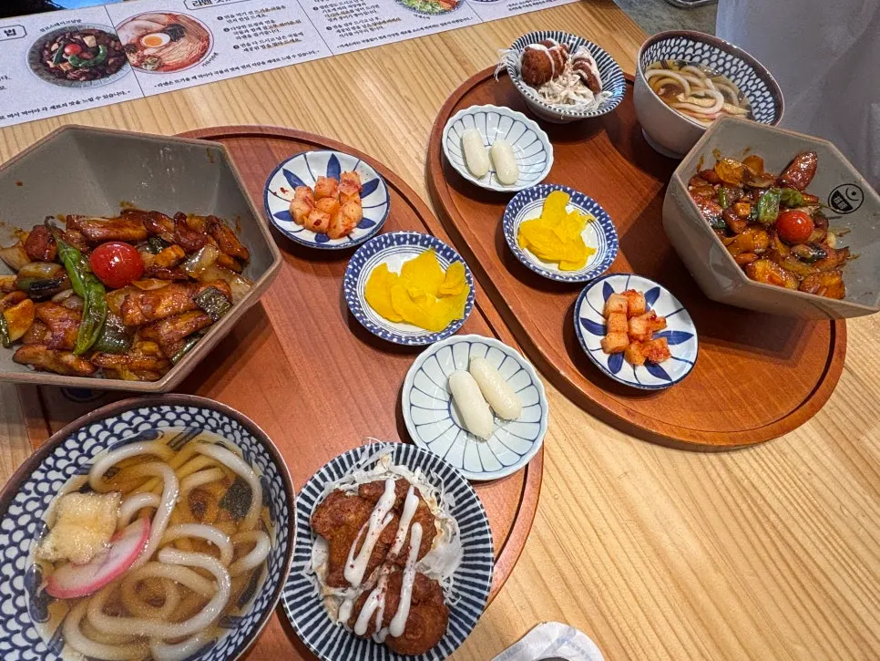 Two spicy pork jowl rice bowl sets laid out on the table