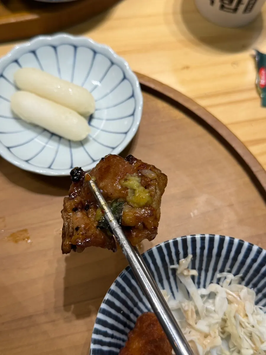 A piece of seasoned rib topped with fresh wasabi
