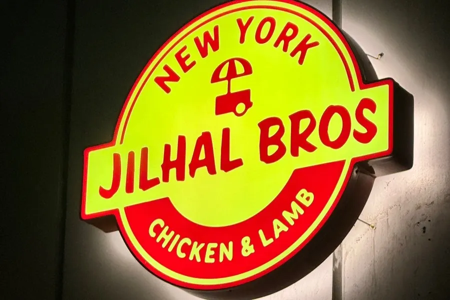 Exterior of Zilhal Bros Sangam with its yellow sign set back inside the Savoy City DMC building