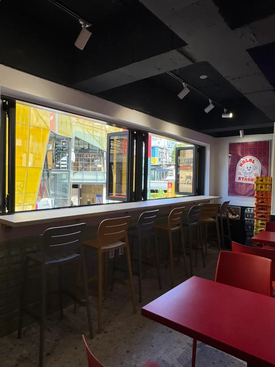 Window seating at Halal Steaks with the folding doors open