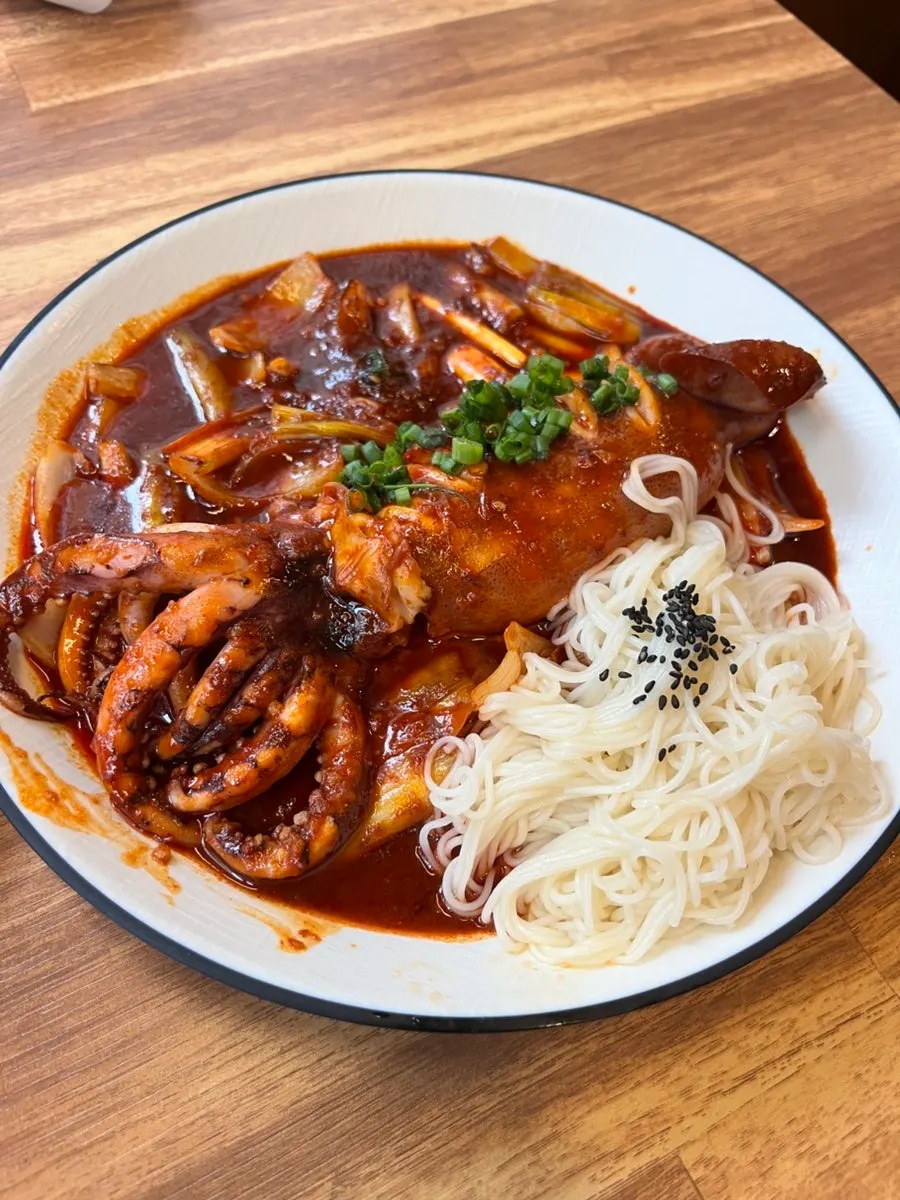 Whole squid stir-fry with a full squid on top