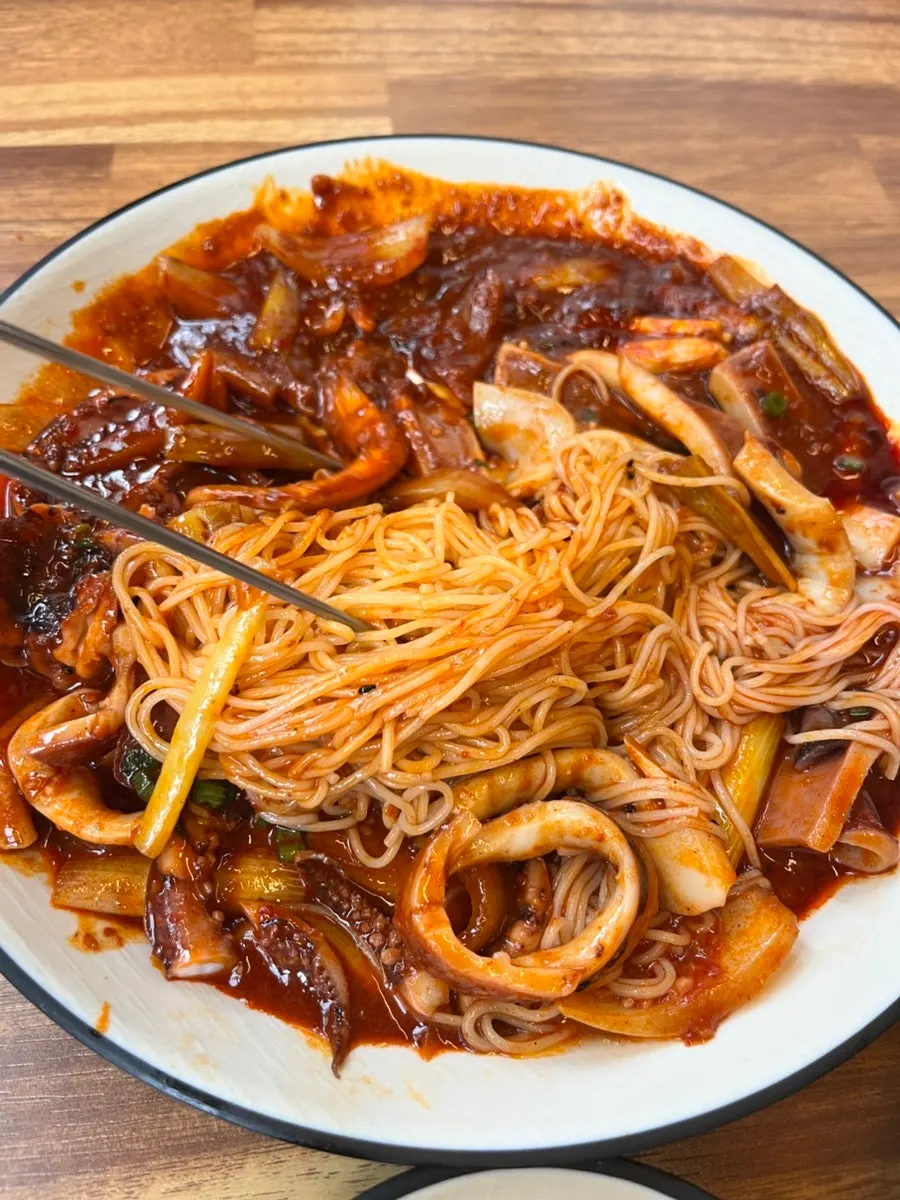 Close-up of whole squid stir-fry coated in sweet-spicy sauce