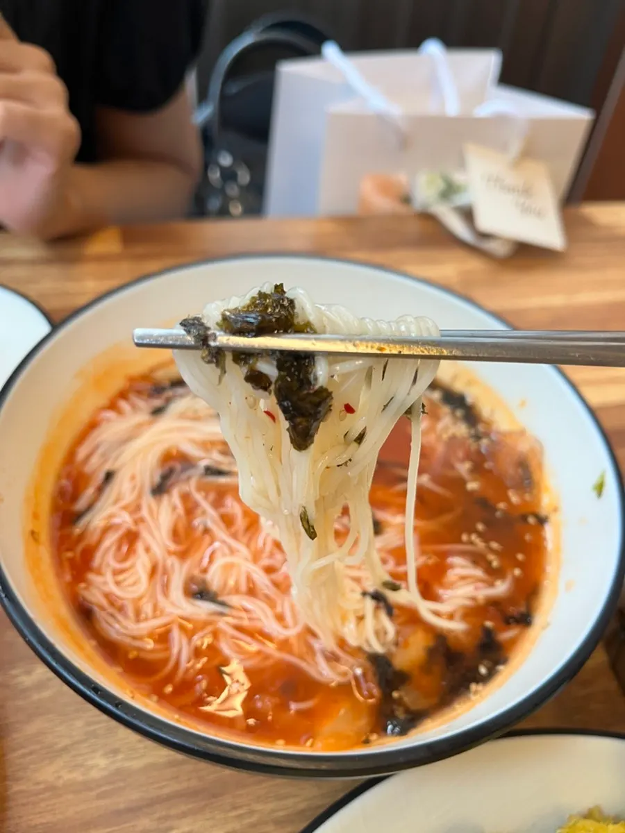 Kimchi mari guksu with icy shaved ice floating on top