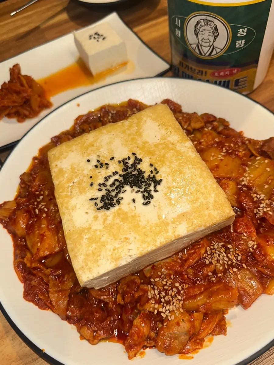Table spread with tofu kimchi, chewy potato and other ordered dishes