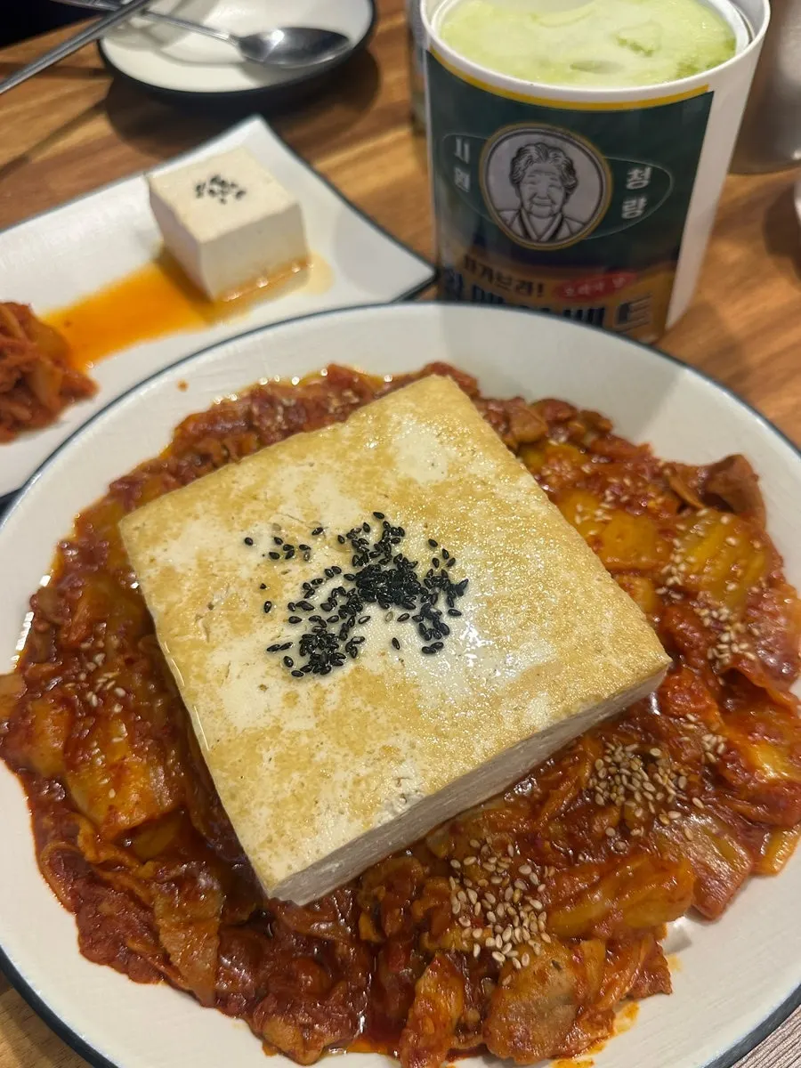 A bottle of Saero on the table with snacks