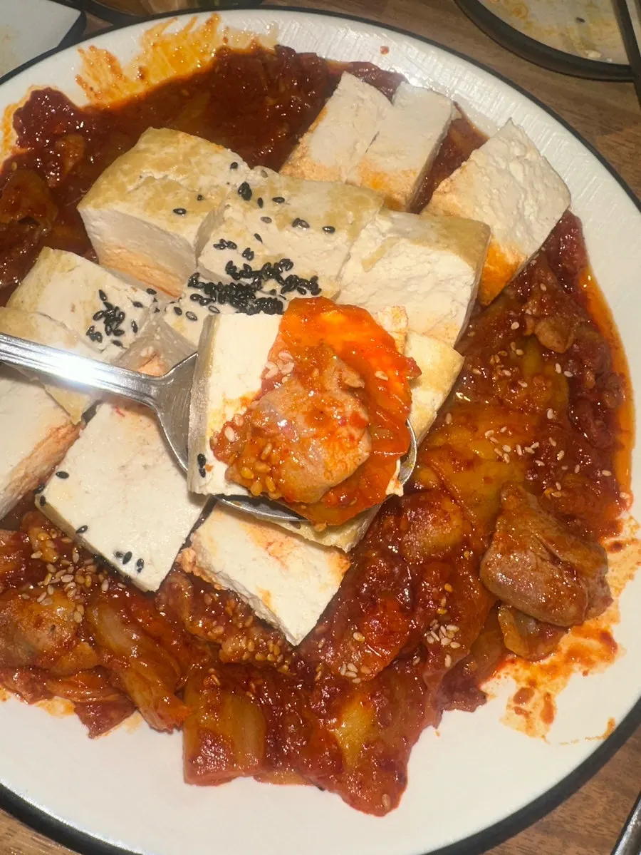 Tofu kimchi served alongside a drink