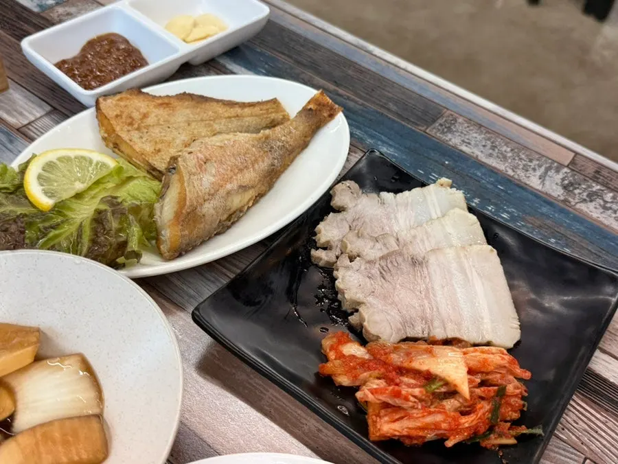 Korean set meal with boiled pork and fish