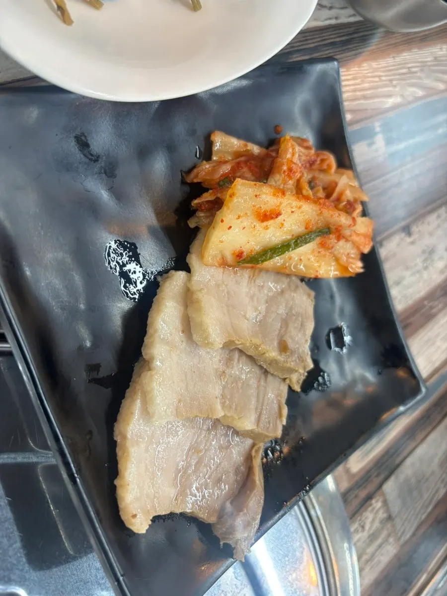 Boiled pork served with kimchi