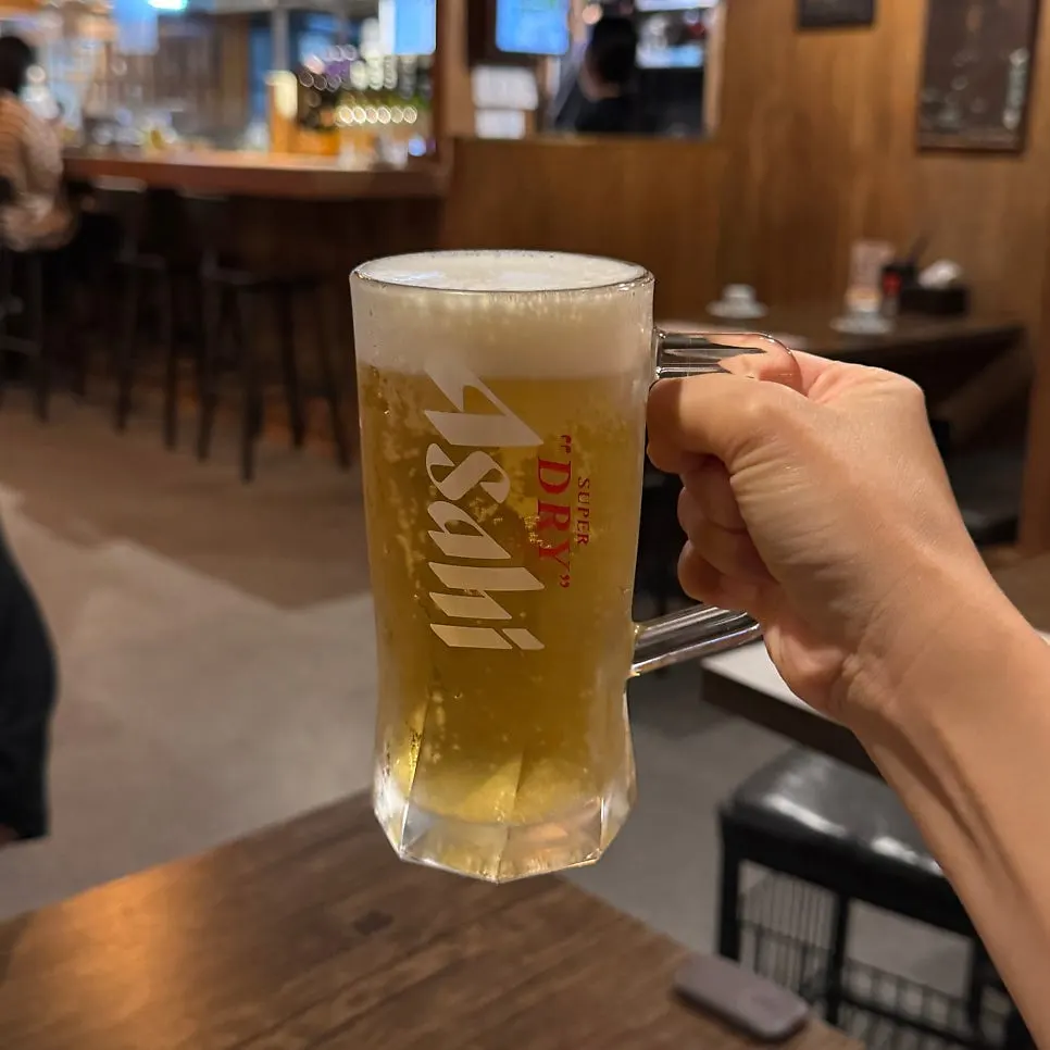 Draft beer served alongside the complimentary side dish