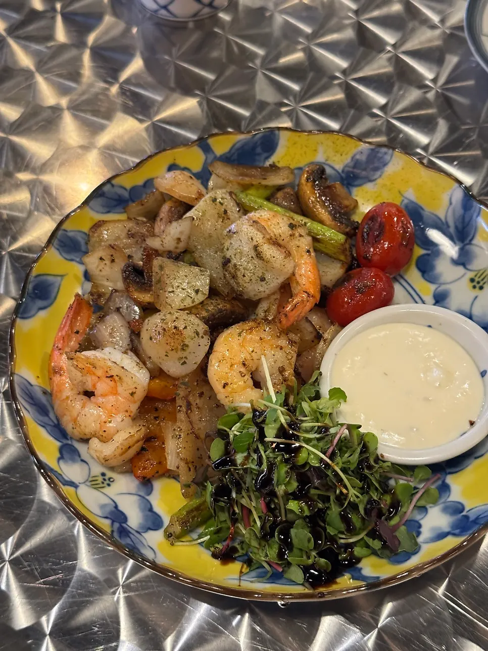 Butter-grilled shrimp and scallops served on a hot plate