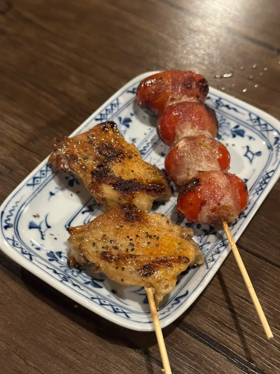 Close-up of chicken tenderloin skewer topped with mentai