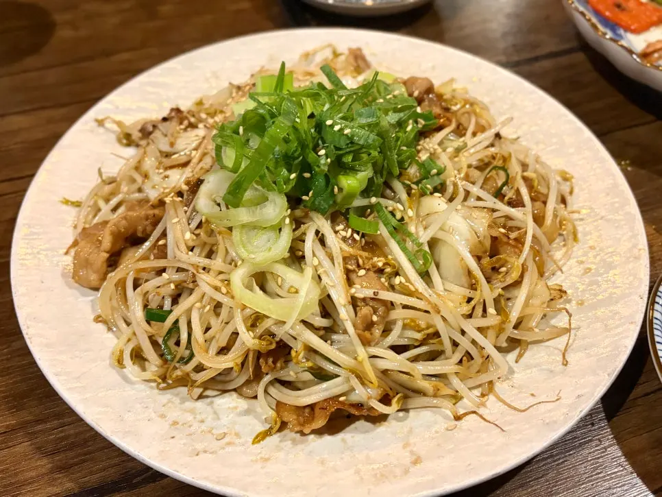 A plate of stir-fried pork belly with bean sprouts