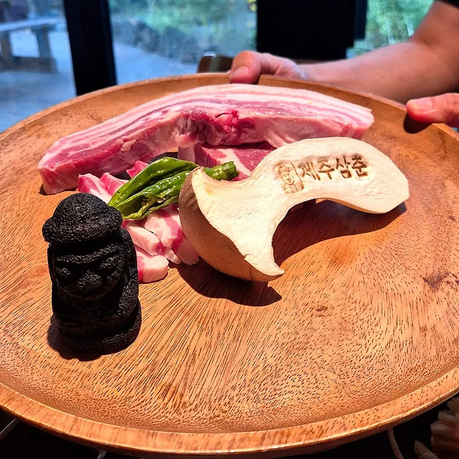 Close-up of grapevine-smoked black pork on the grill