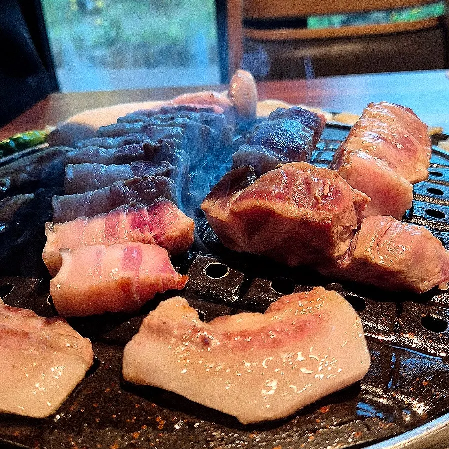 A piece of black pork with a salt dish