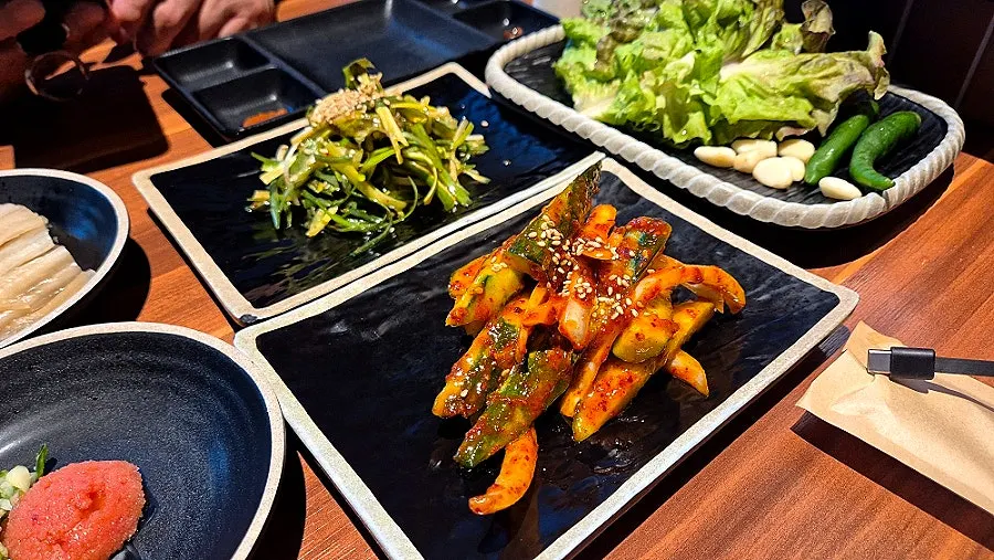 Black pork set served with a dolhareubang figure