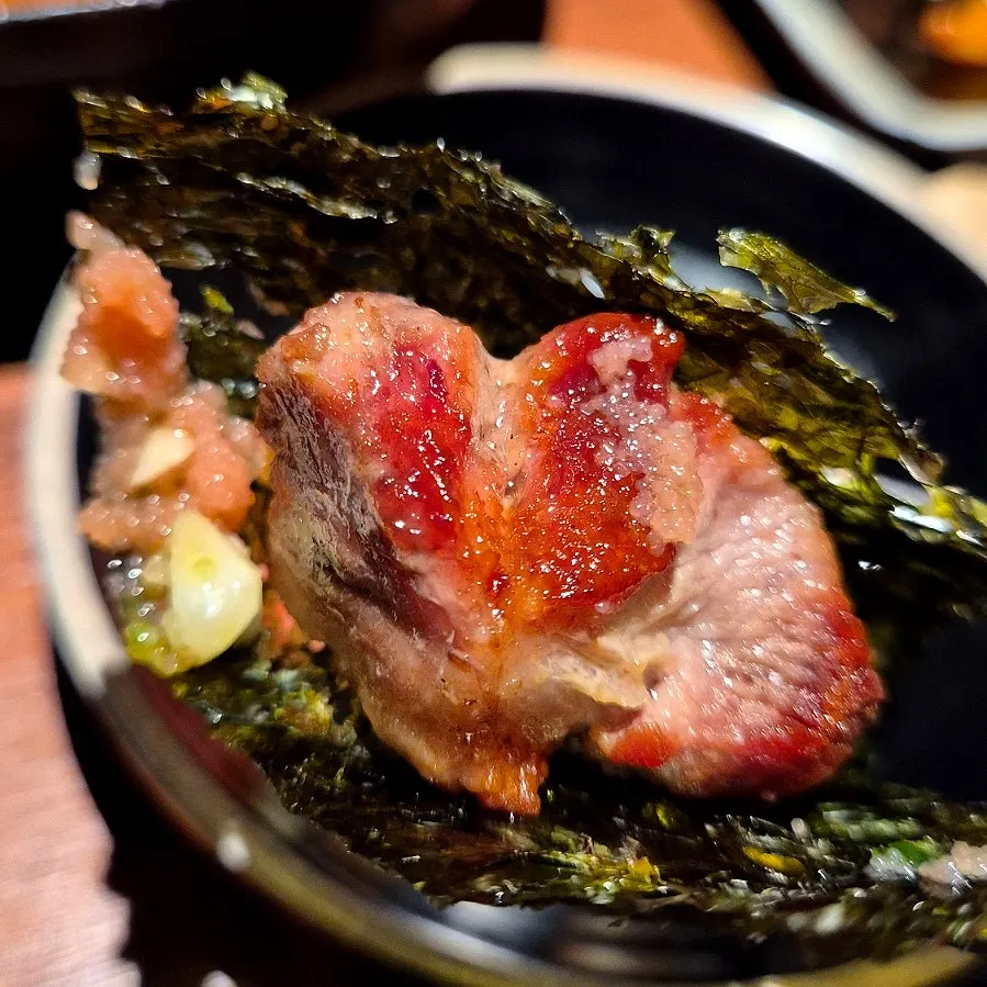 Black pork wrapped in lettuce and pickled radish