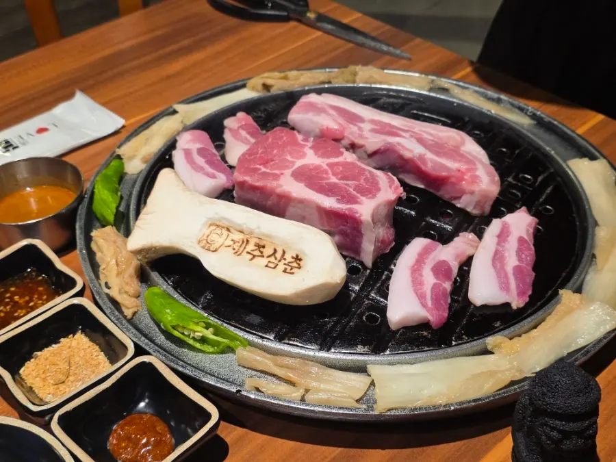Bright red black pork and a mushroom stamped with the restaurant's name