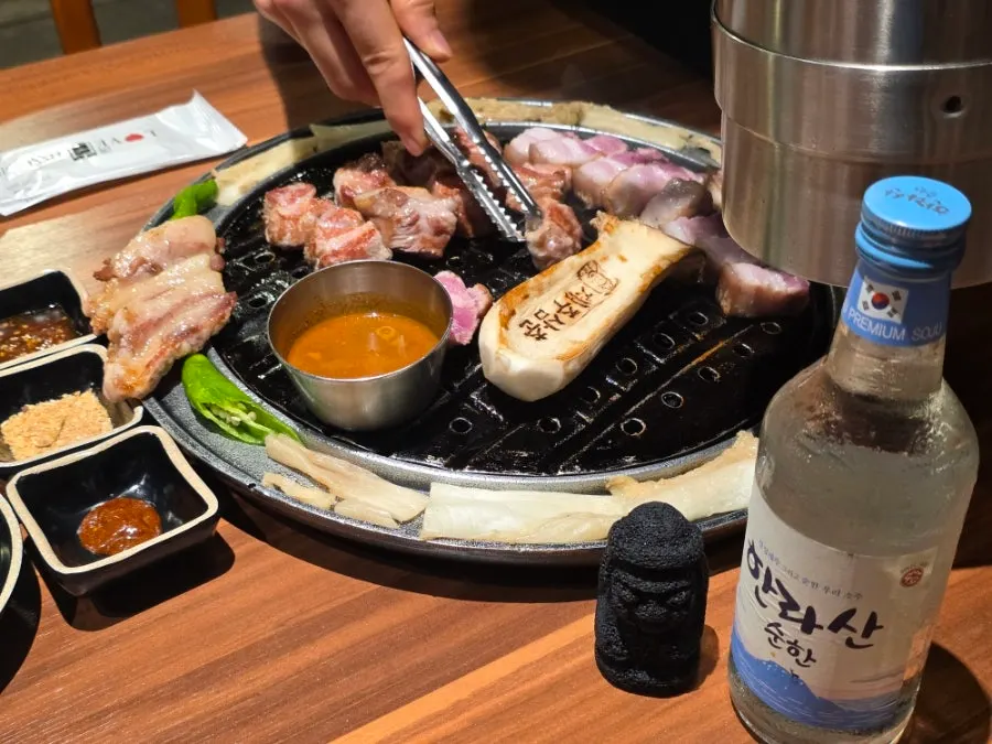 Staff grilling thick cuts of black pork on the grill plate