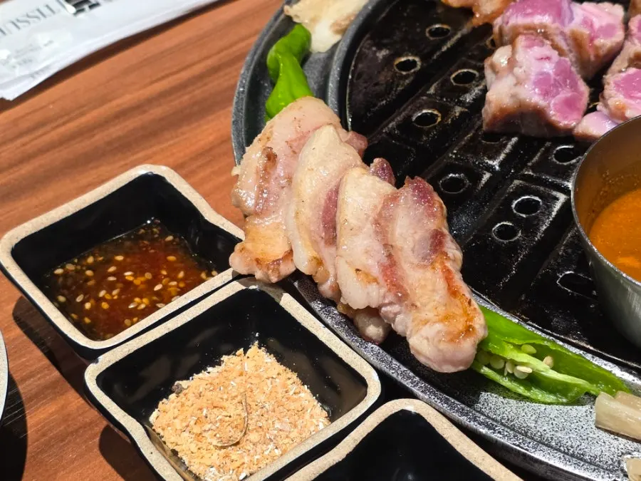 Black pork being grilled according to its thickness
