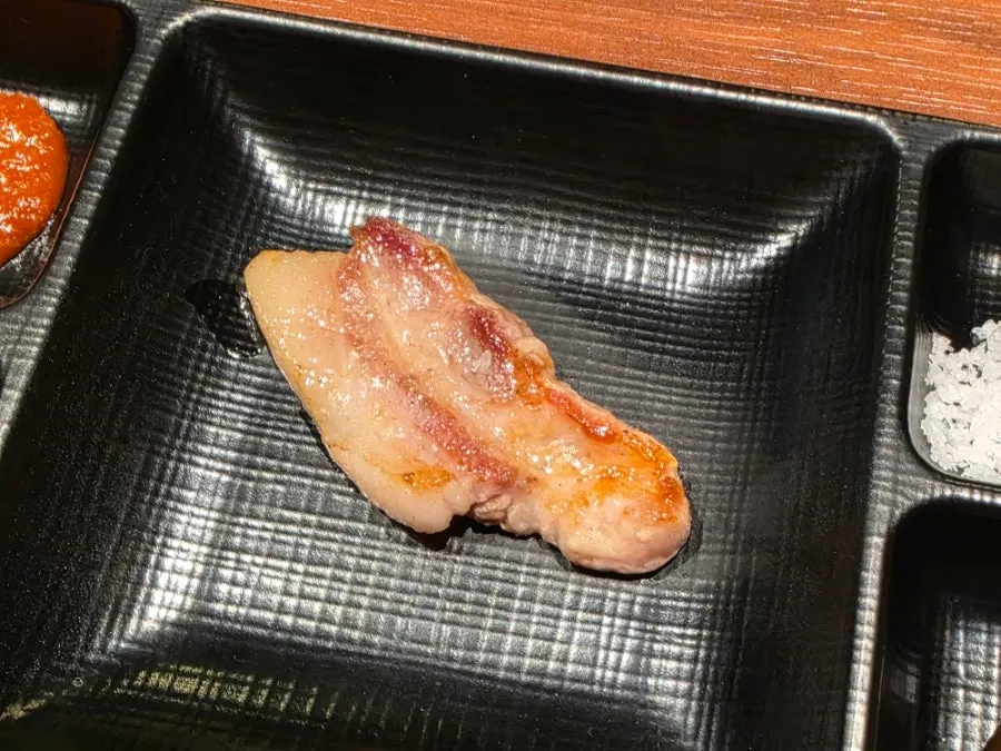 Fully grilled black pork moved to the side of the grill