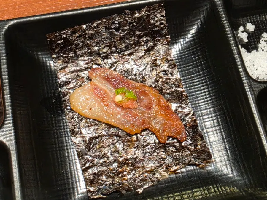 Kim-ssam wrap with a piece of black pork on seaweed