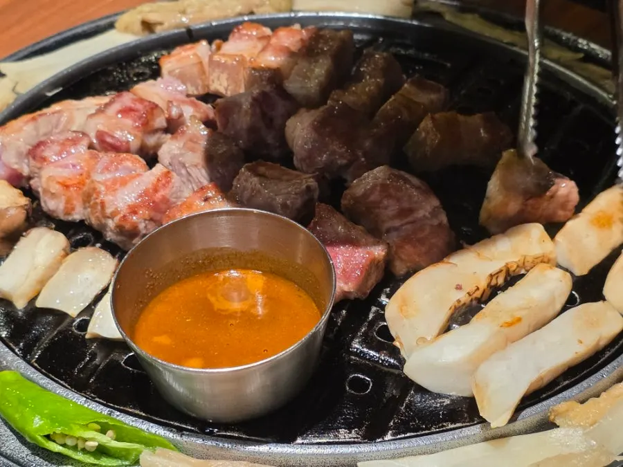 Meat on the grill plate with smoke aroma spreading