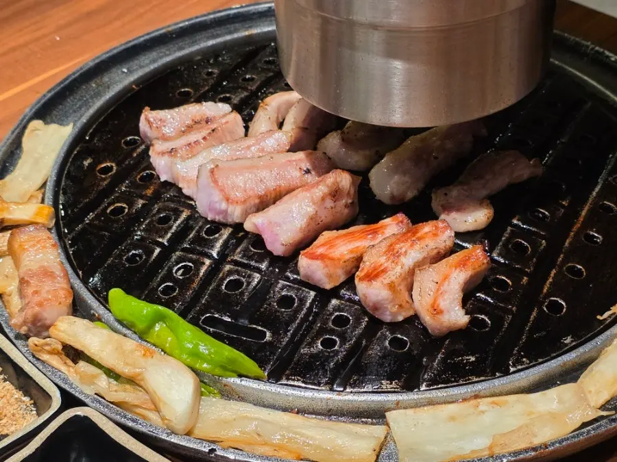 Extra order of pork jowl cooking on the grill