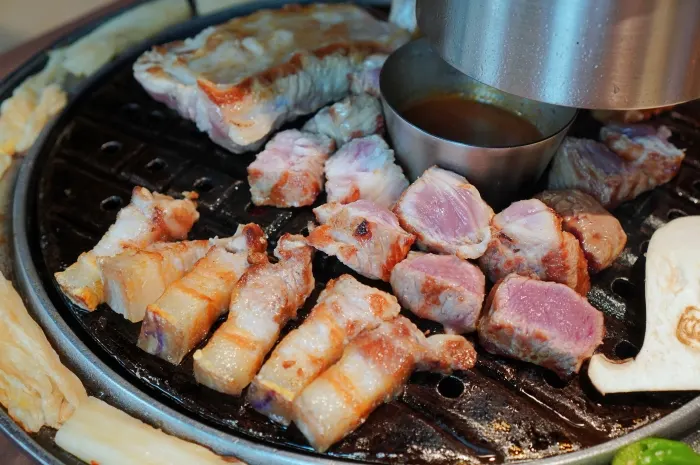 Family table set with black pork dinner