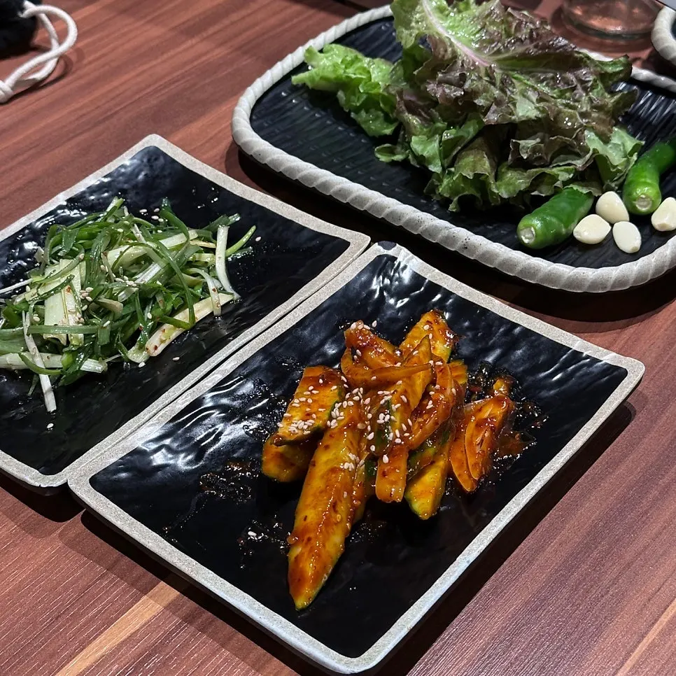 Lettuce wraps, cucumber salad, and scallion salad side dishes