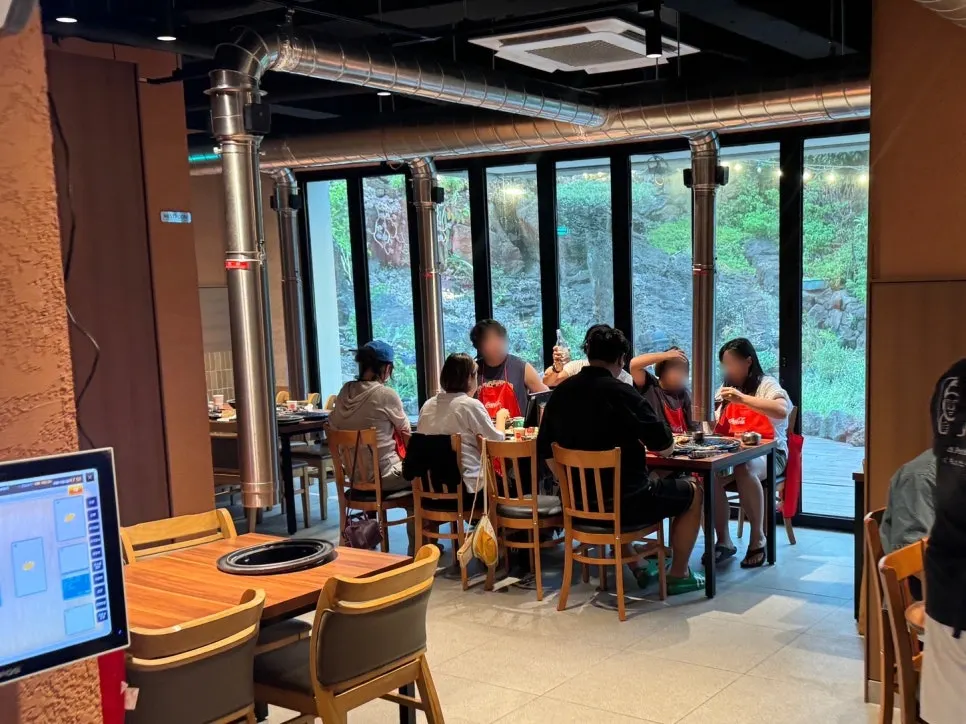 Clean dining hall seating at Jeju Samchun black pork
