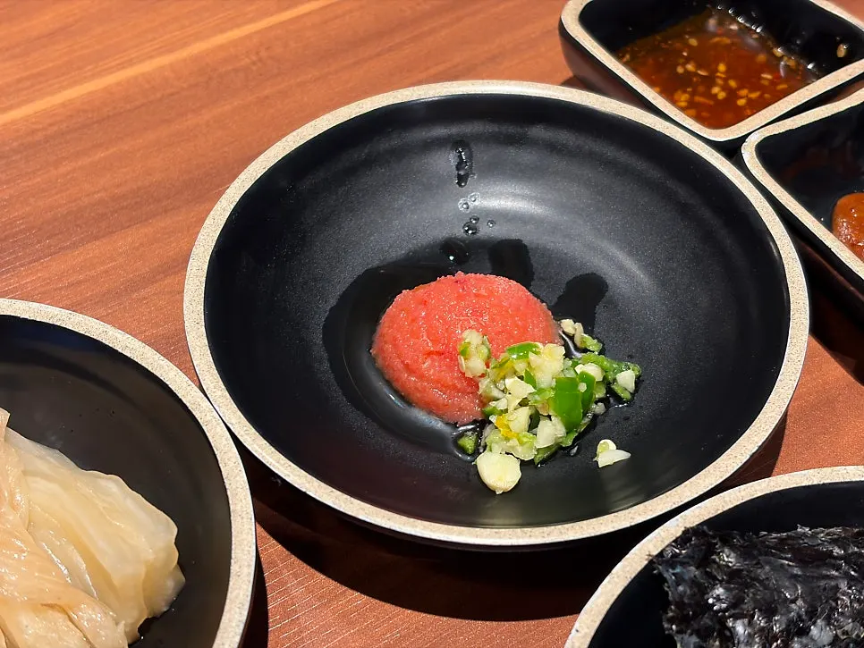 Ssam vegetables, basic side dishes, and sauces set out
