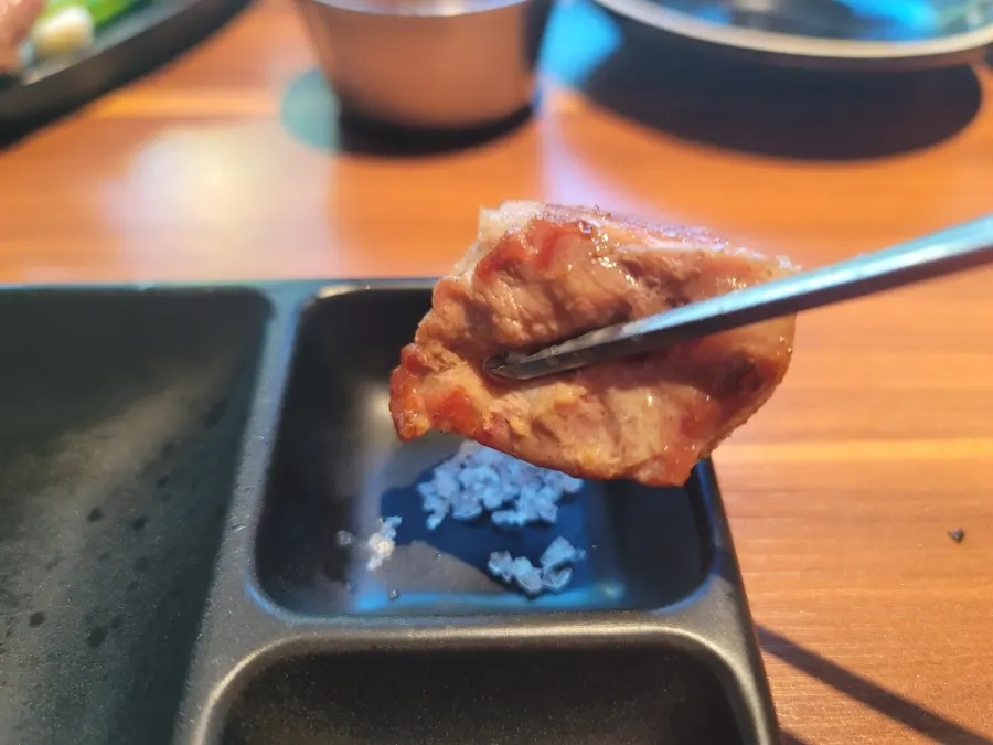 First bite of black pork dipped only in salt