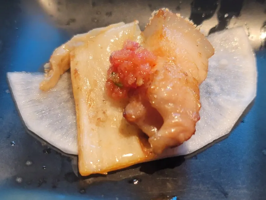 Black pork piece served with pickled radish and scallion shreds
